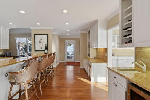 Plenty of countertop seating and a wet bar with wine refrigerator.