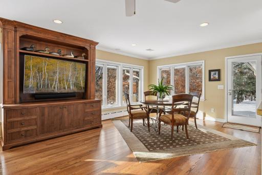Informal dining area captures view of the lake and woods.