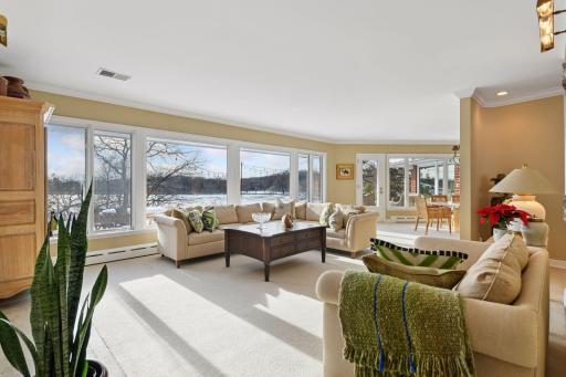 The living room offers a sweeping view of Bryant Lake.