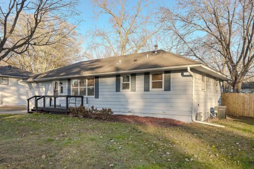 Photo for 719 Keniston Street N, Champlin, MN 55316 - listing #6817561 The front exterior of the home, showing a classic rambler design, attached garage, and a wide driveway with plenty of parking space.