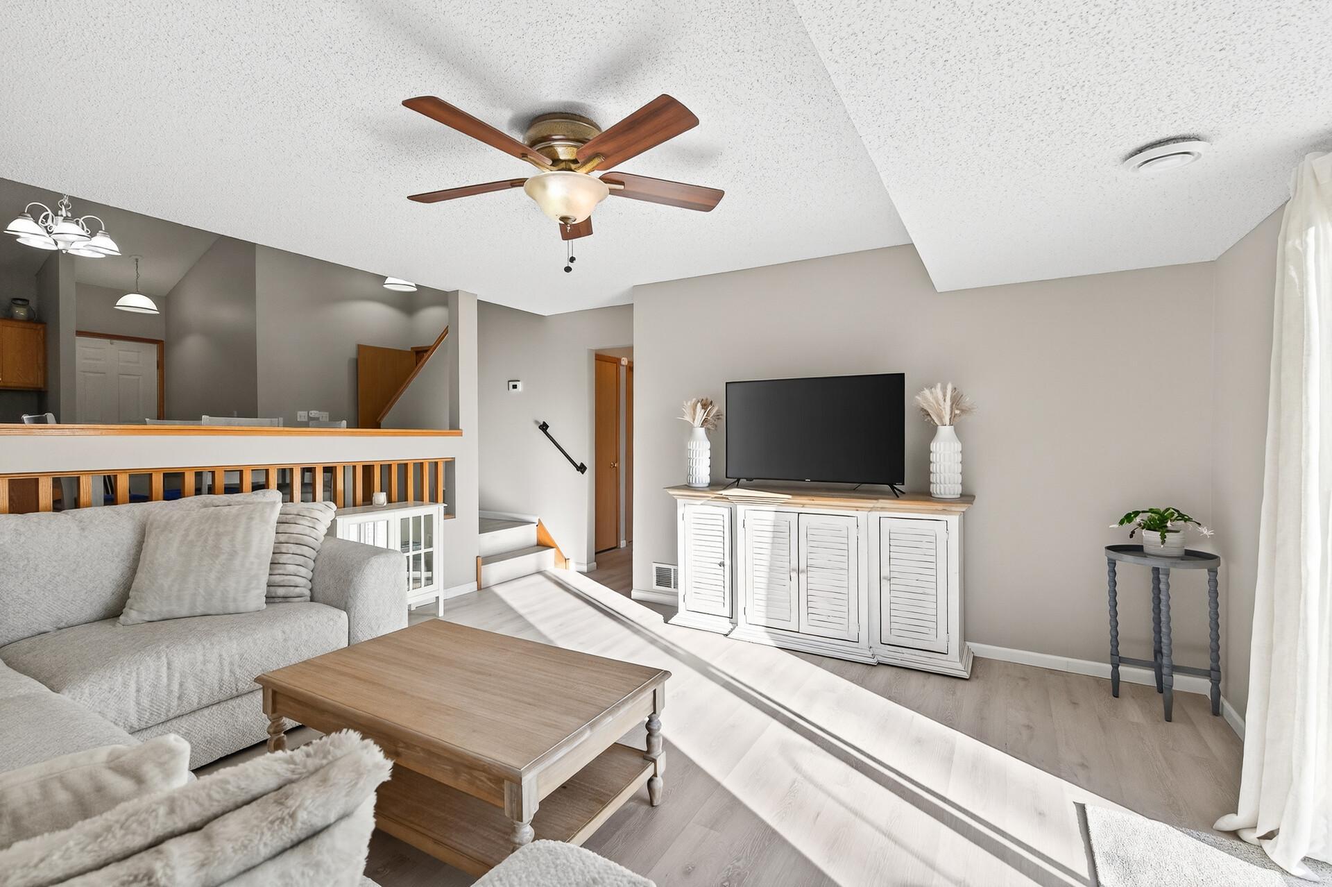 Bright walkout living room with large sliding glass door, great natural light, and easy access to the outdoor patio.