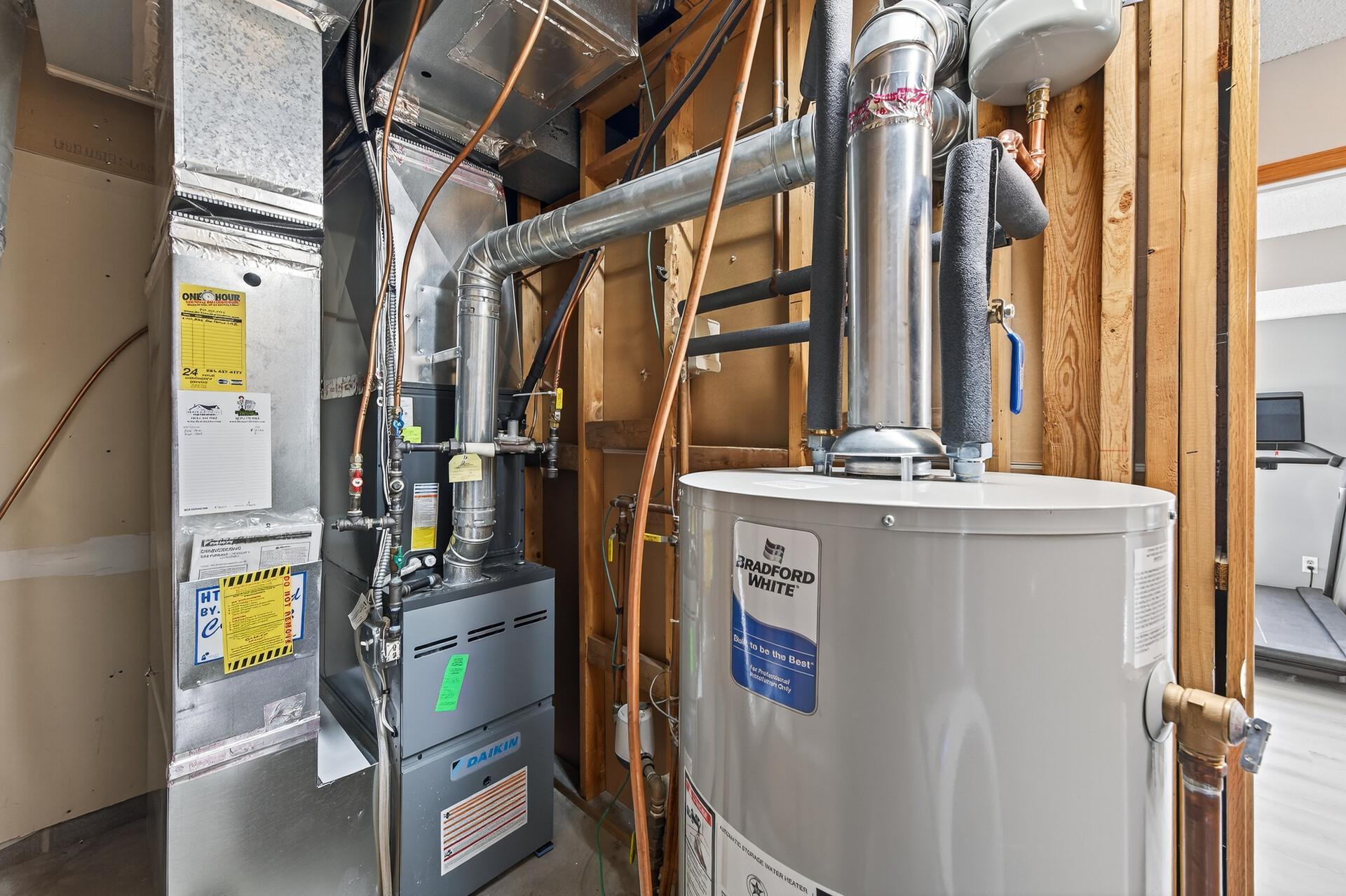 Mechanical room featuring furnace, water heater, and easy access to major home systems. Seller updates note furnace/AC in 2022 and water heater in 2025.