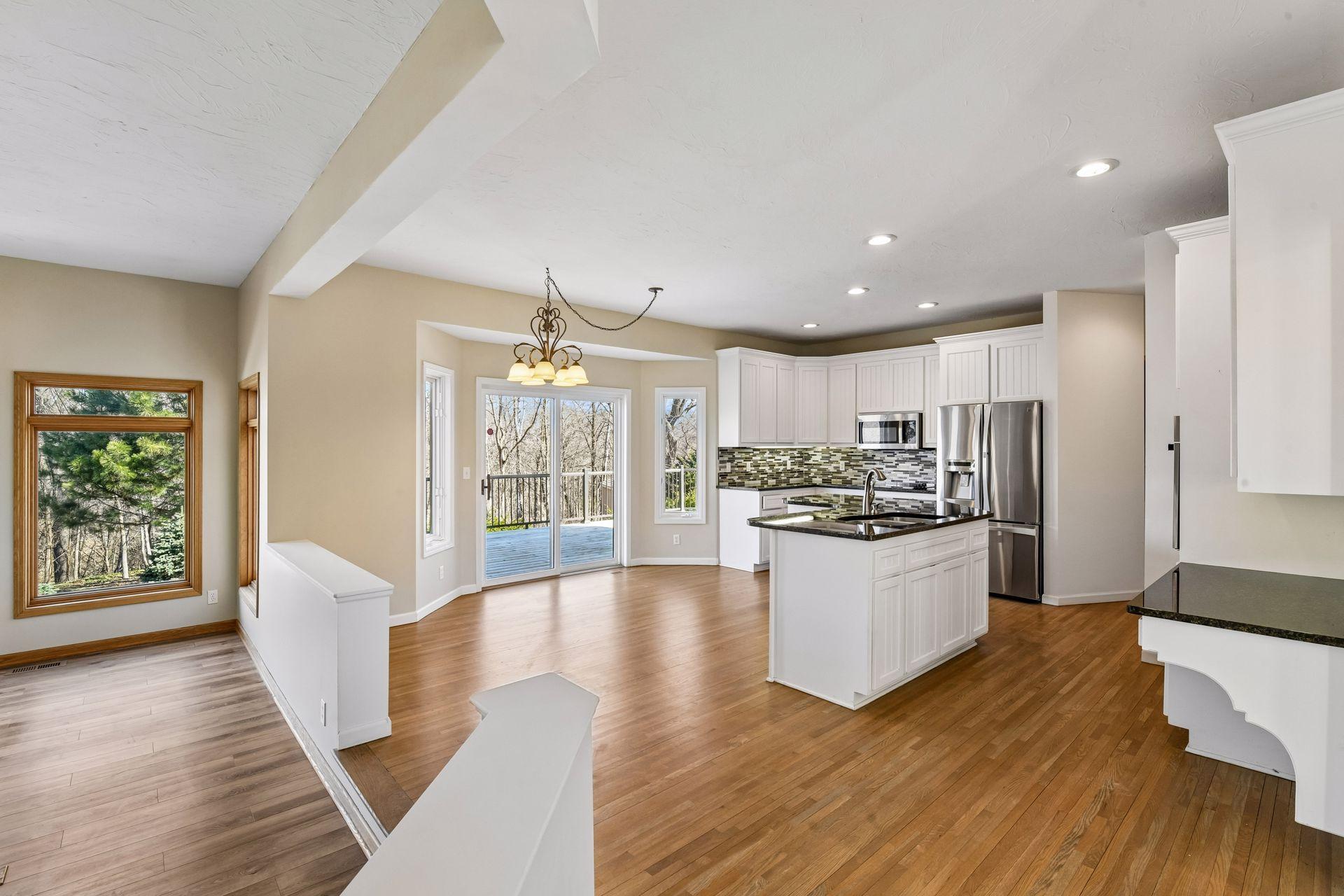 The kitchen and dining space opens directly to the expansive deck via sliding glass doors. It’s a great feature for summer BBQs and morning coffee overlooking the woods!