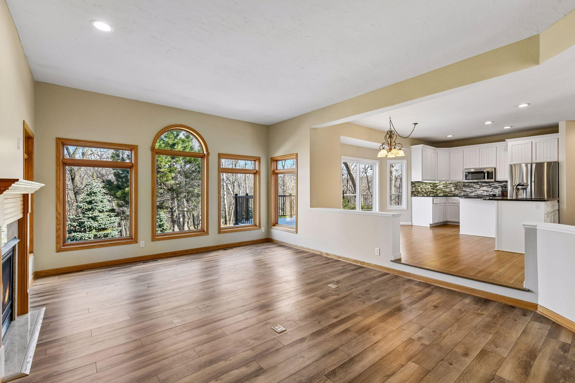 An entertainer’s dream! The massive, sun-drenched open-concept layout flows effortlessly into the kitchen, offering a grand, versatile space ready for your personal touch