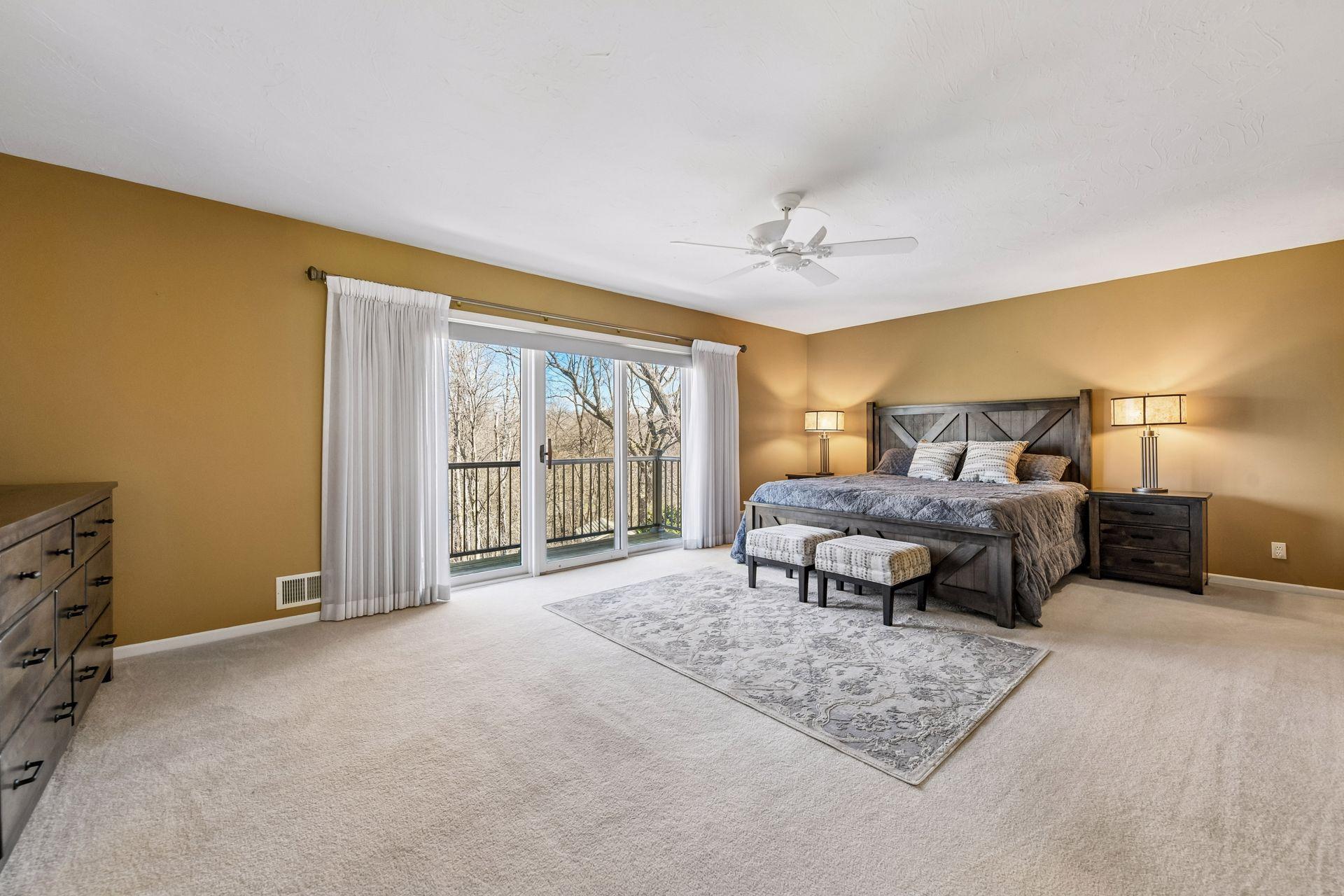 Massive 22x14 primary suite offers an abundance of space and natural light. Enjoy a private retreat with large sliding doors that open to a scenic balcony overlooking the woods!