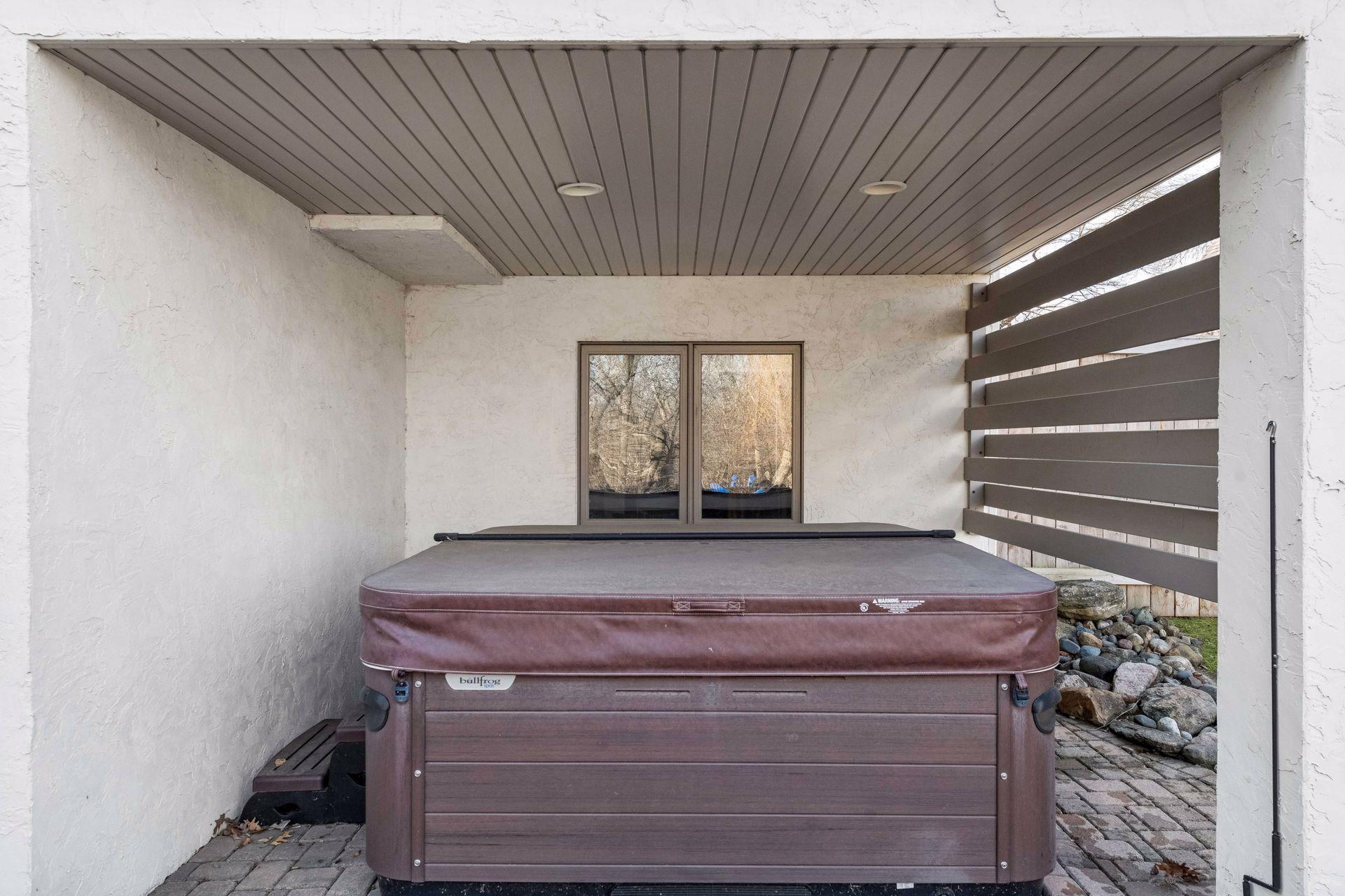 One more incredible touch! This covered hot tub offers a private, year-round spa experience. Tucked away on the patio for ultimate relaxation, it is included with the home!