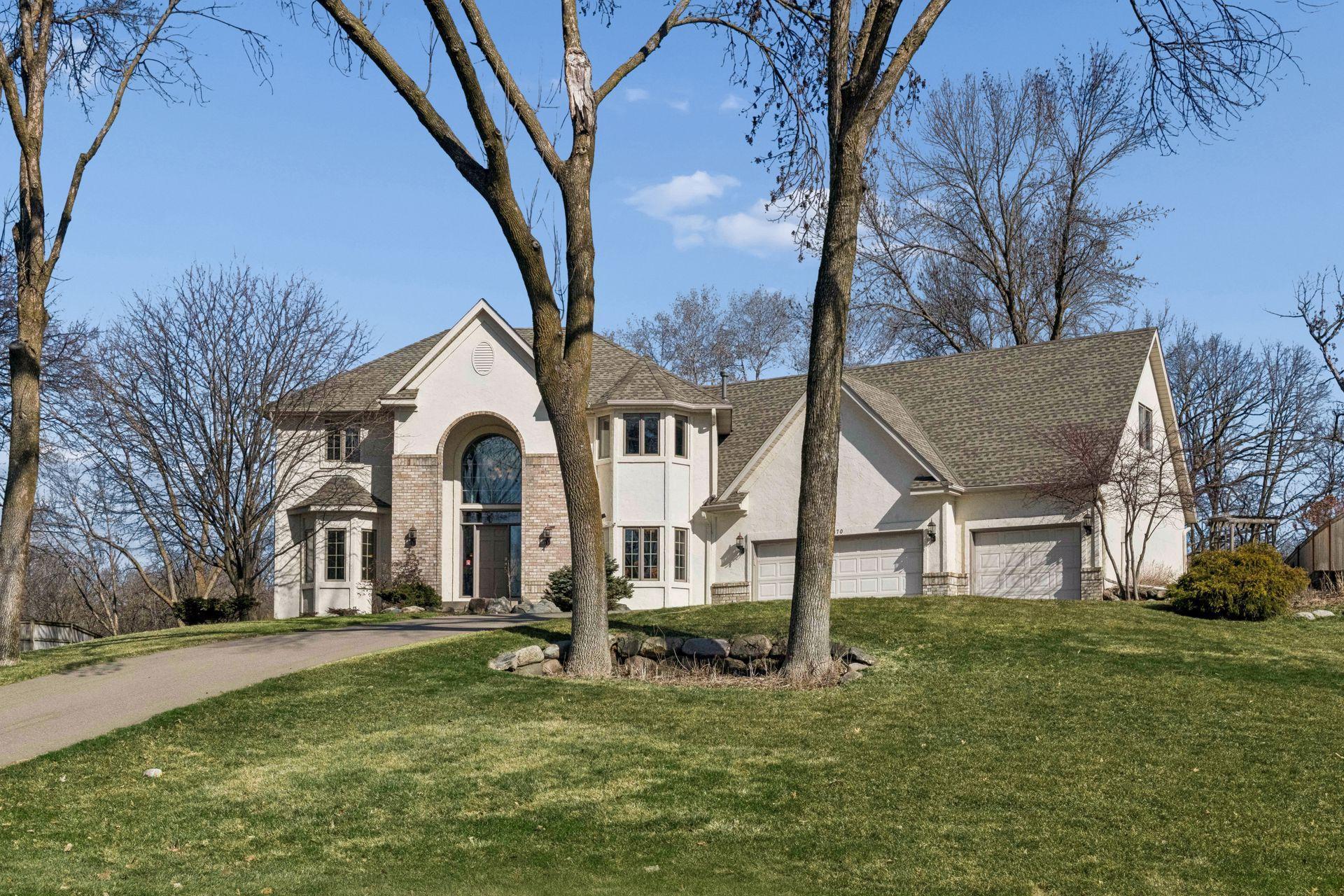 Stunning 4BR Minnetonka walkout on a private 1-acre lot backing to Purgatory Creek Preserve.