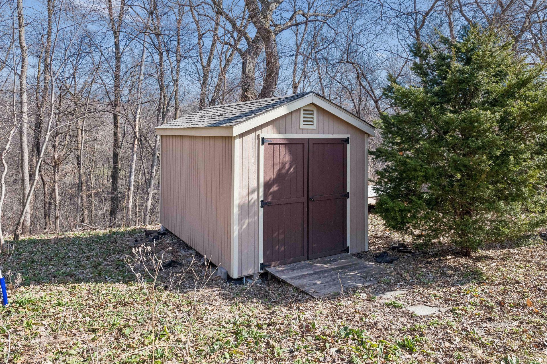 A close up of the storage shed- a perfect spot for all your lawn tools!