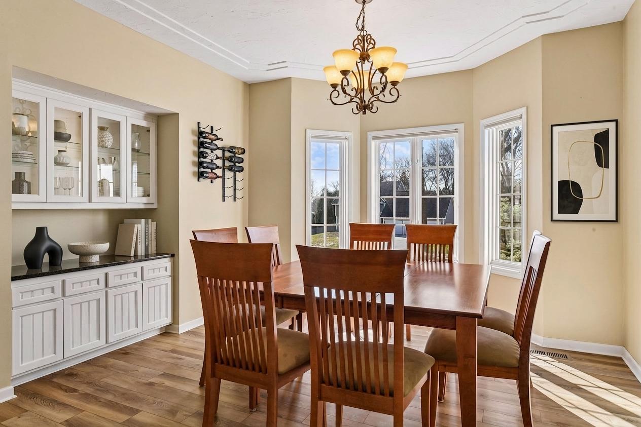Host in style! The elegant dining room features bayed windows, a custom built-in hutch, and a sophisticated tray ceiling. Perfect for formal gatherings! *Virtually staged to show design options.