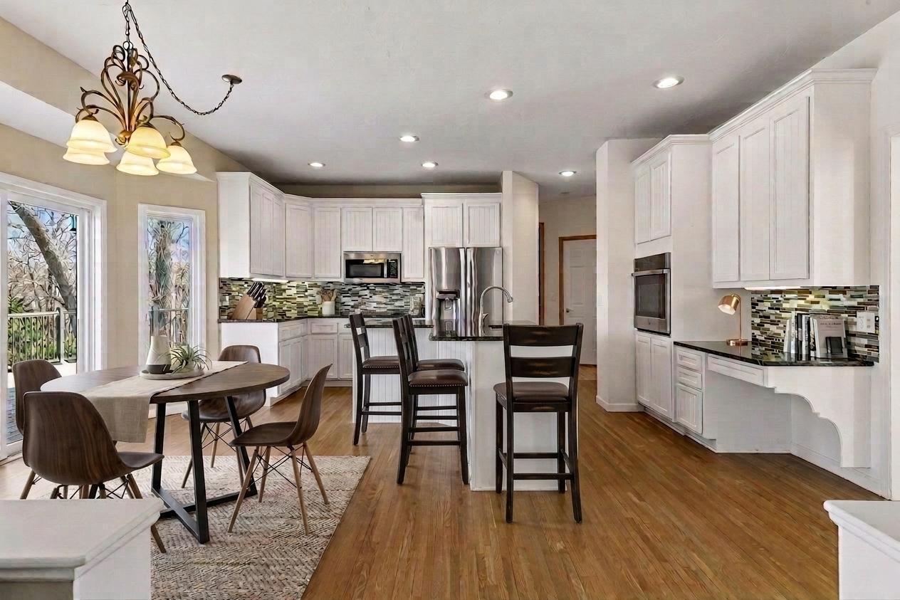 Chef’s kitchen with white enameled cabinetry, granite countertops, and a social center island. Bright space also features a built-in planning desk! *Virtually staged to show design options.