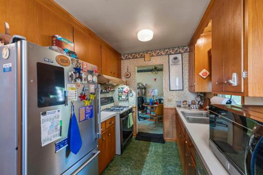 The kitchen includes a stainless steel dishwasher and a stainless steel Maytag refrigerator, updated in 2022.