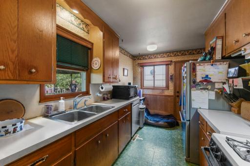 A window above the sink provides peaceful views of the backyard, and a convenient side door leads to the large deck and fully fenced yard.
