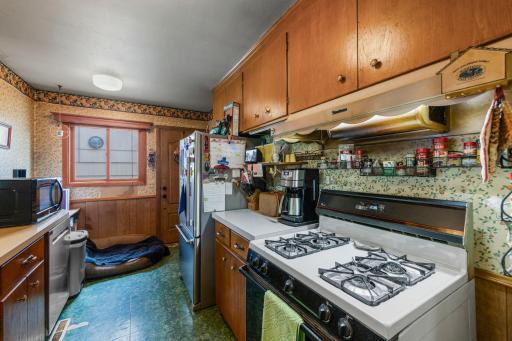 Alternate view of the kitchen showcasing the side door that leads out to the deck.