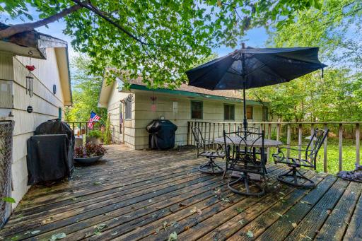 The large backyard deck offers the perfect setting for relaxing or entertaining, with mature trees providing a peaceful, natural backdrop.