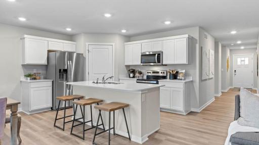 Photo for 1036 Goldenrod Trail, Waconia, MN 55387 - listing #6818478 Modern kitchen with stainless steel appliances and microwave venting outside. Model home, finishes will vary.