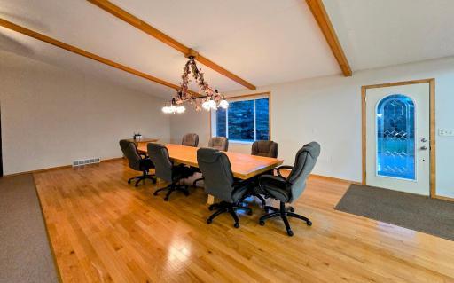 Beautiful oak flooring extends to the formal dining area with vaulted ceiling & front door access from the patio.