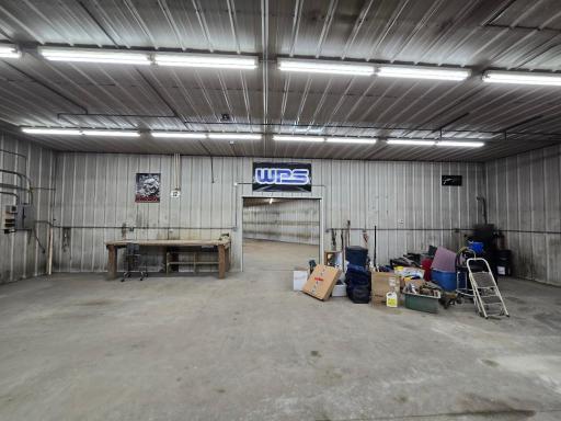 East wall of machine shed has roll up door into the furnace/boiler room area of the shed.