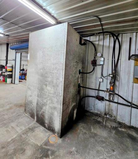 Boiler wrapped up behind enclosed casement.