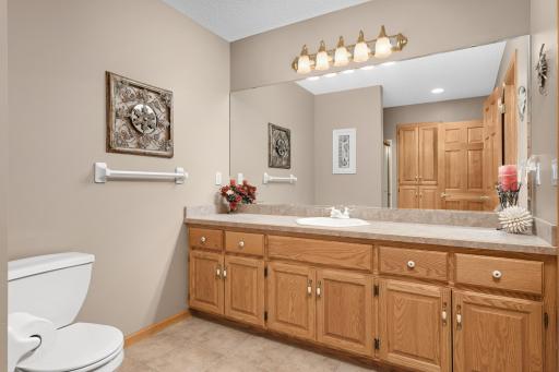 Lower level 3/4 bathroom with extra long built-in vanity, and linen closet storage.