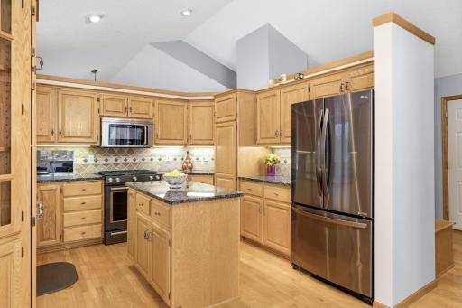 Updated granite countertops with tile backsplash and under cabinet lighting.