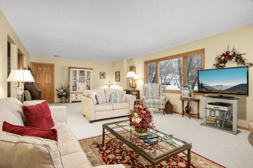Spacious lower level with an abundance of unfinished storage with shelving.