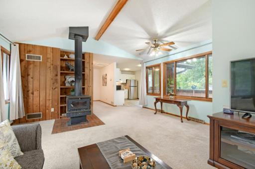 The living room facing the other direction. Note the wood burning stove and kitchen to the right.