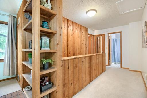 At the top of the steps you will find one bedroom, a full bathroom. Head around the corner to the living room and kitchen areas.