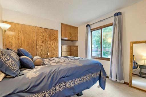 The upper-level bedroom is spacious and offers extra built-ins.