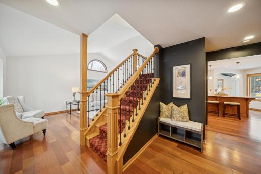 Your welcomed into the home by a solid wood and iron staircase. A powder room, and coat storage on the right and a formal living area is to the left. The kitchen is straight ahead.