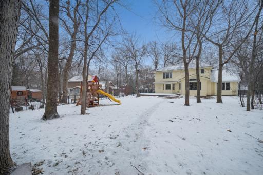 Large fenced yard and playset.