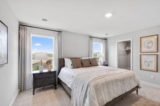Private primary suite with room for a king size bed, dual vanities and oversized, walk-in closet. Photo is of model home. Colors and options may vary. Ask Sales Agent for details.