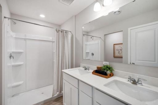 Private primary suite with room for a king size bed, dual vanities and oversized, walk-in closet. Photo is of model home. Colors and options may vary. Ask Sales Agent for details.