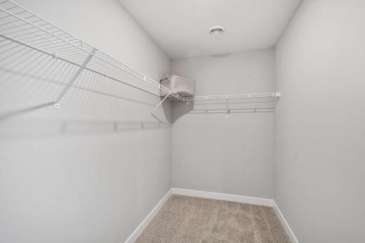 Private primary suite with room for a king size bed, dual vanities and oversized, walk-in closet. Photo is of model home. Colors and options may vary. Ask Sales Agent for details.