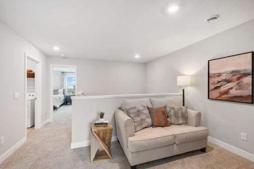 Convenient upper level loft space - perfect for a TV, game area, or working from home. Photo is of model home. Colors and options may vary. Ask Sales Agent for details.