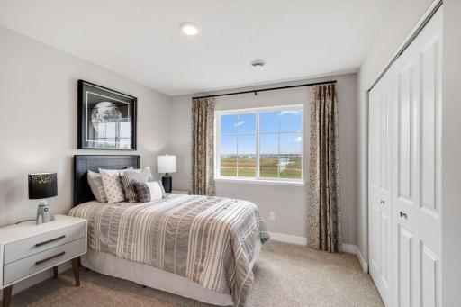 Two secondary bedrooms ideal for guests, office, or hobbies. Photo is of model home. Colors and options may vary. Ask Sales Agent for details.