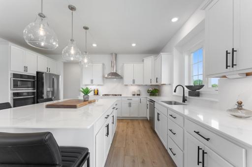Photo for 8887 Binder Alley, Woodbury, MN 55129 - listing #6819061 (Photo of a similar home, actual homes finished will vary) Welcome to the Snelling! This spacious gourmet kitchen features a large center island, quartz countertops, LVP floors, stainless steel appliances, and more.