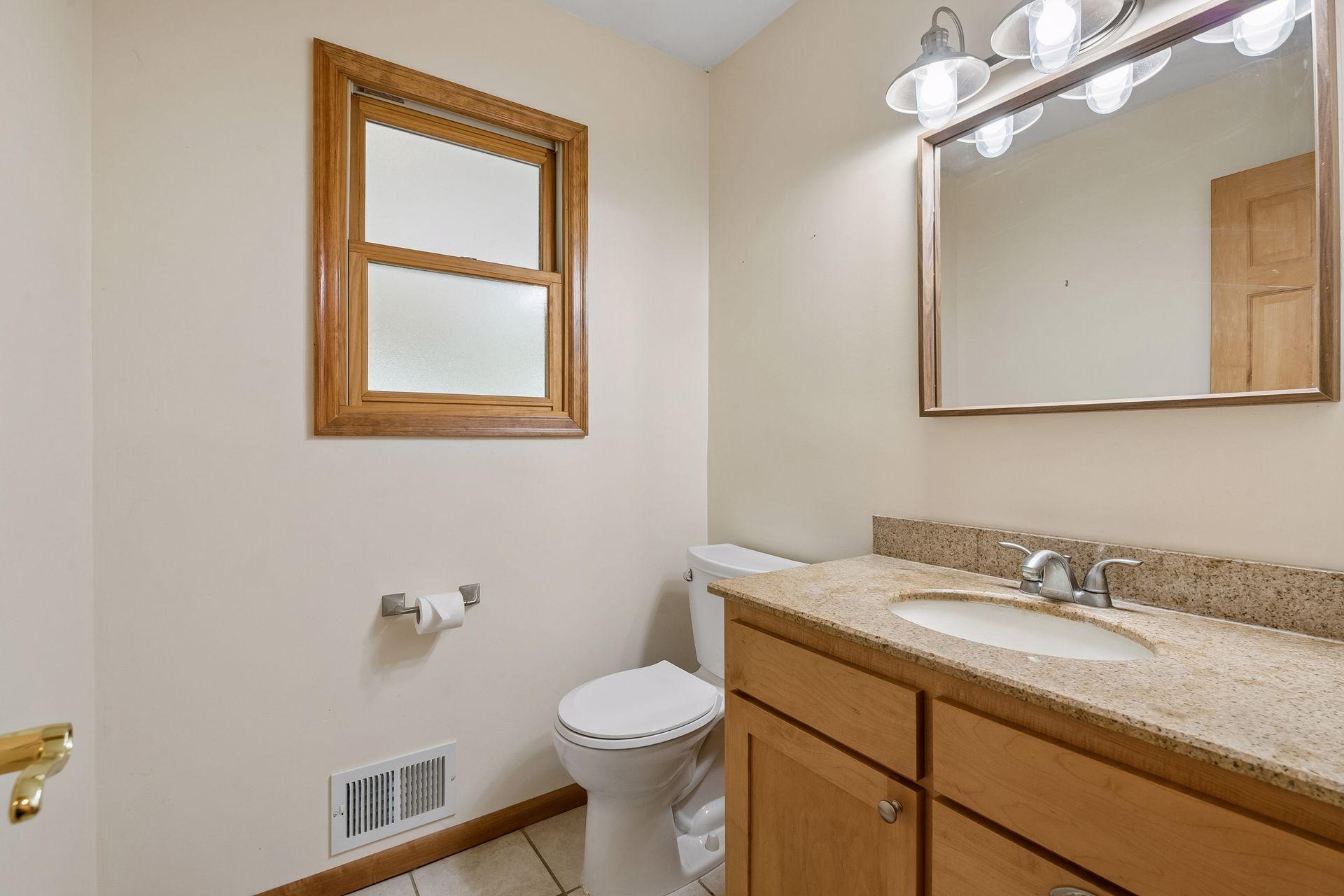 Your main floor powder room is conveniently located between the kitchen and the entry suite area of the home.