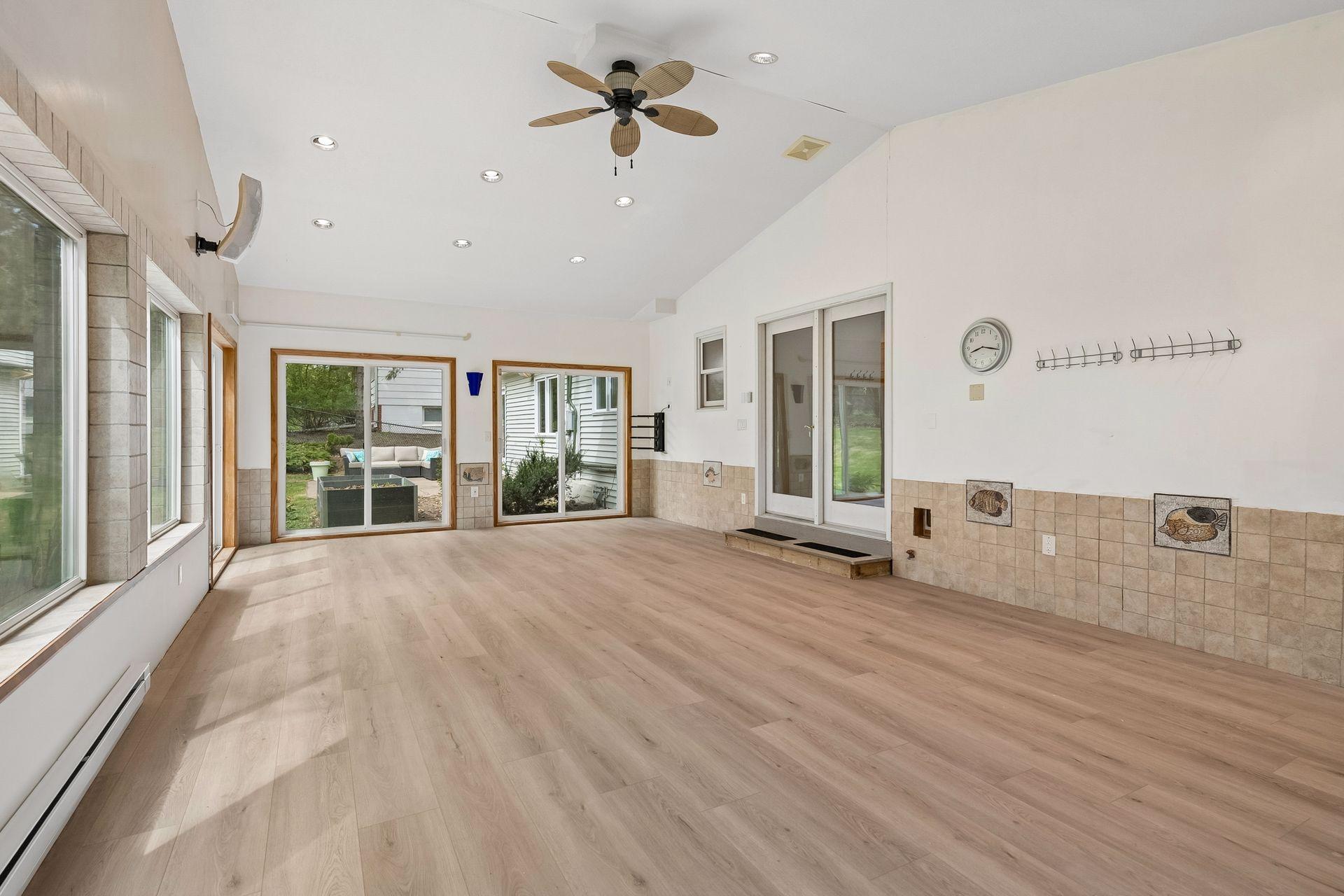 This spacious sunroom offers two walls of windows and a vaulted ceiling!