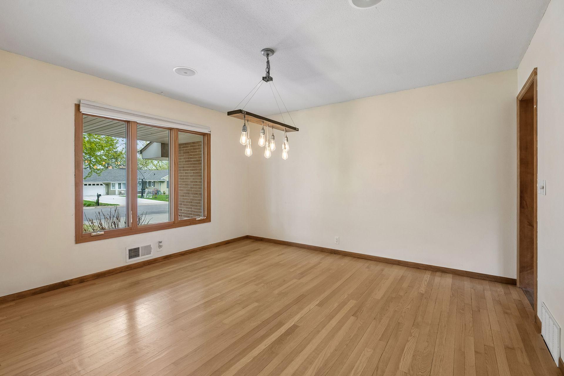 Dining room facing front and east wall with entrance to the kitchen,