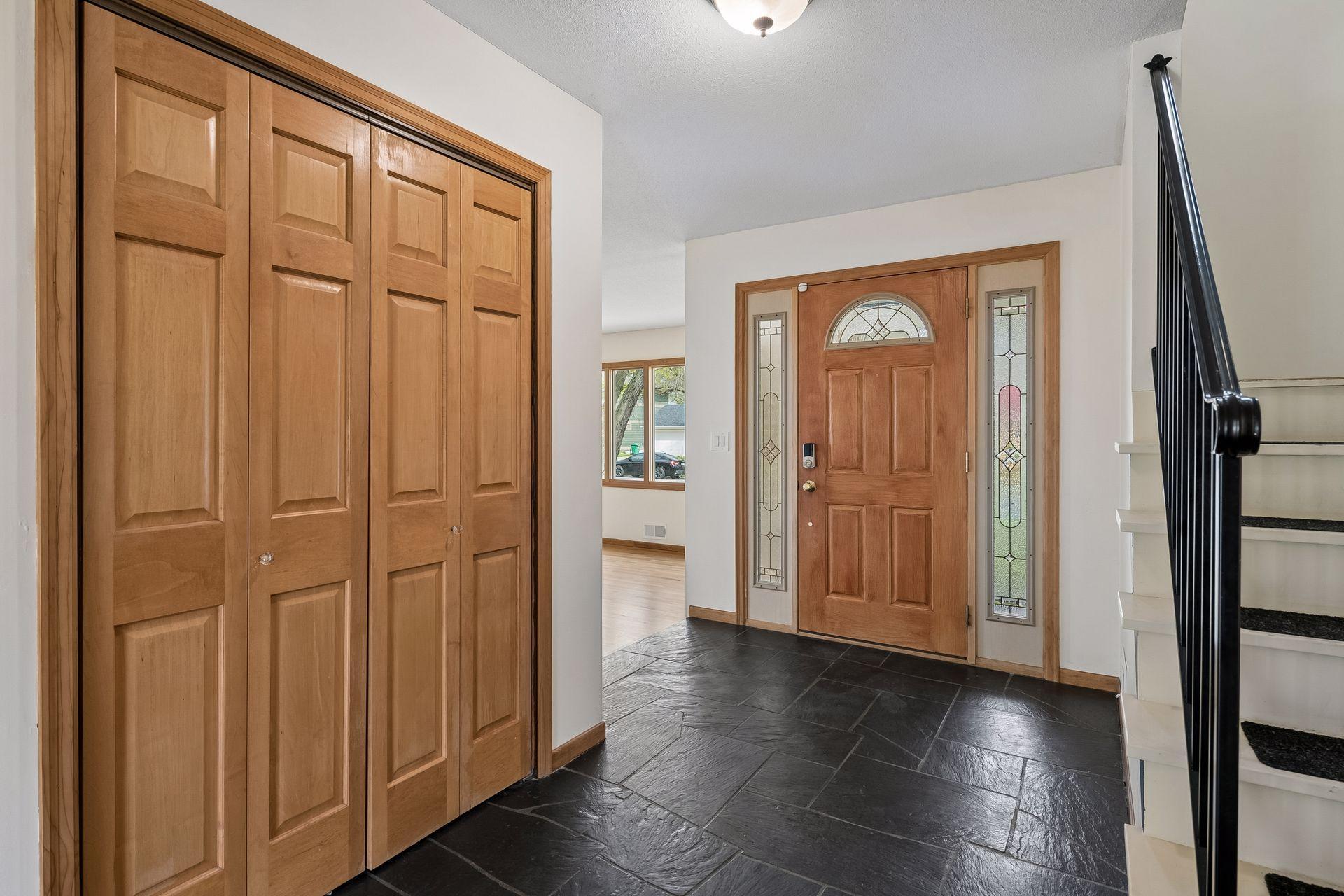 The foyer is appointed with a very accommodating coat closet.