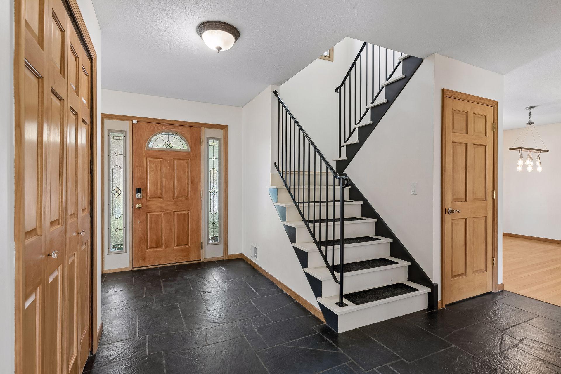 The spacious foyer is perfect for greeting your visitors! Original slate flooring!