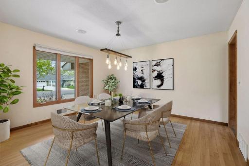 Dining room facing front and east wall with entrance to the kitchen. Virtually Staged.