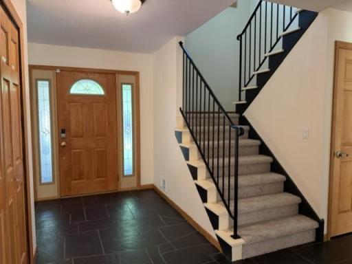 The stair to the upper level bedrooms and the door to the lower level.