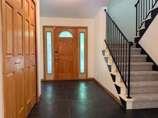 The spacious front entrance with original slate floors and a large coat closet is a wonderful space for welcoming guests!