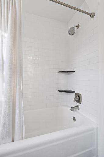 Newly tiled shower in upstairs full bathroom.