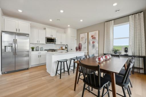 (Photo of decorated model, actual homes colors and finishes will vary) Open and naturally bright, the home's kitchen space is highly desirable.