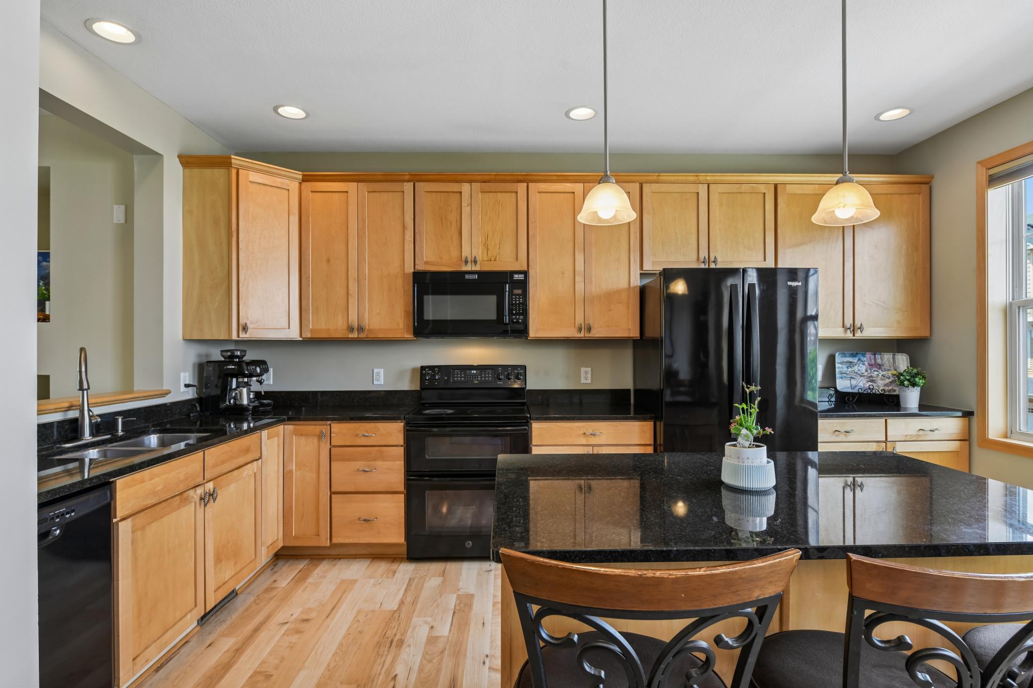 Large kitchen with an abundance of 42" cabinets, granite counters, generously size center island, and beautiful hardwood floors