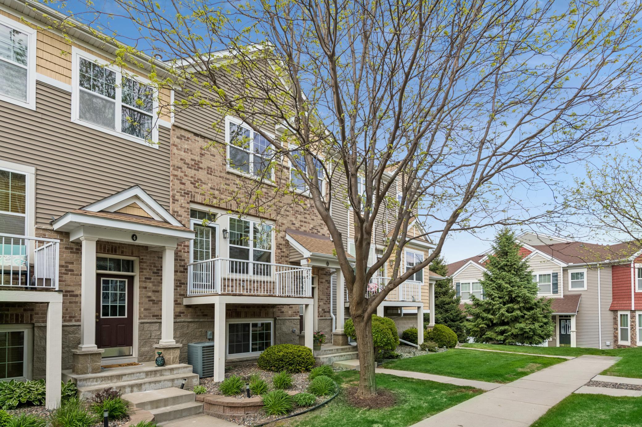 Courtyard setting with mature trees and green grass to add to the appeal!