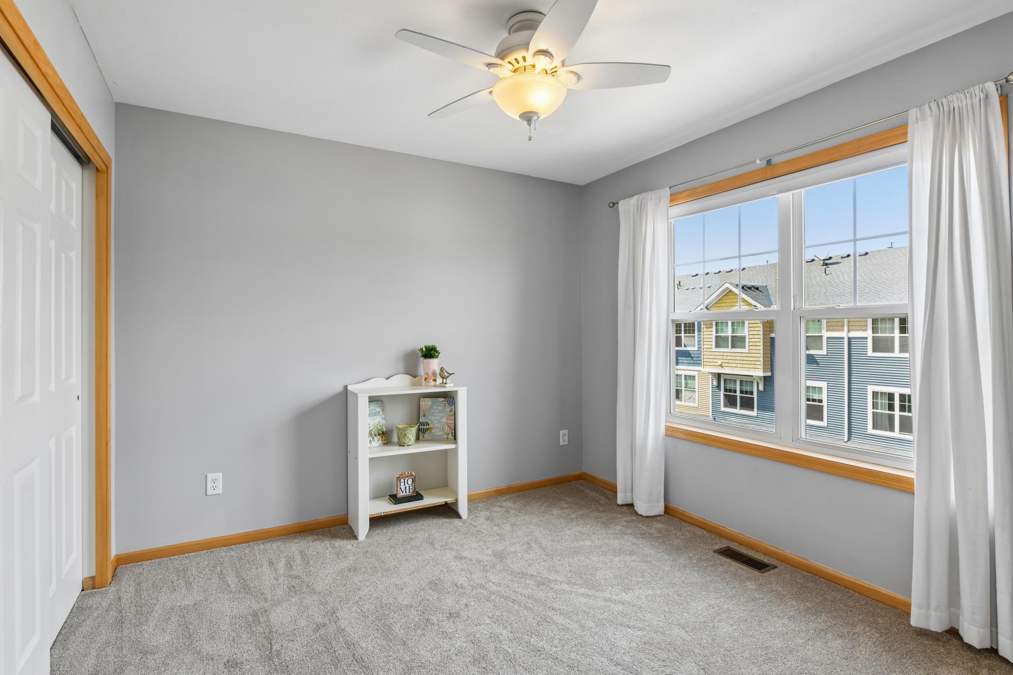 Three bedrooms on upper level all with ceiling fans, large windows, fresh paint, and new carpet and pad (2026).
