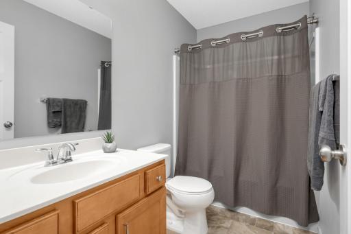 Full bathroom serving the upper level with functional layout and clean, neutral finishes.